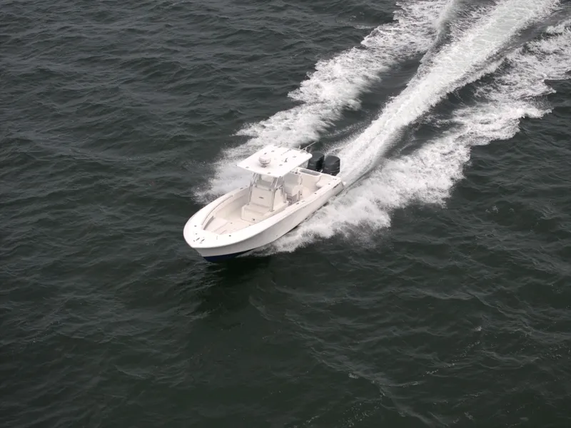 Slide: The Image of 2012 Invincible 33 Open Fisherman boat cruising on open water. - 9