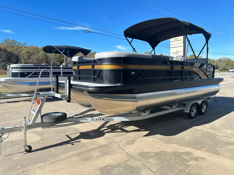 Slide: The Image of 2025 Bennington 23 SSB pontoon boat on trailer, black and silver design. - 2