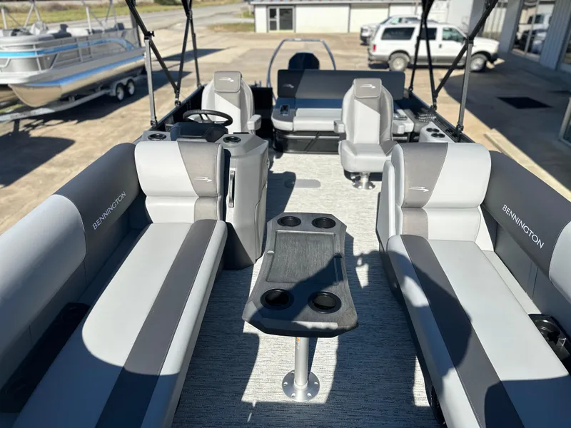 Slide: The Image of 2025 Bennington 23 SSB pontoon boat interior with gray seating and cup holders. - 7