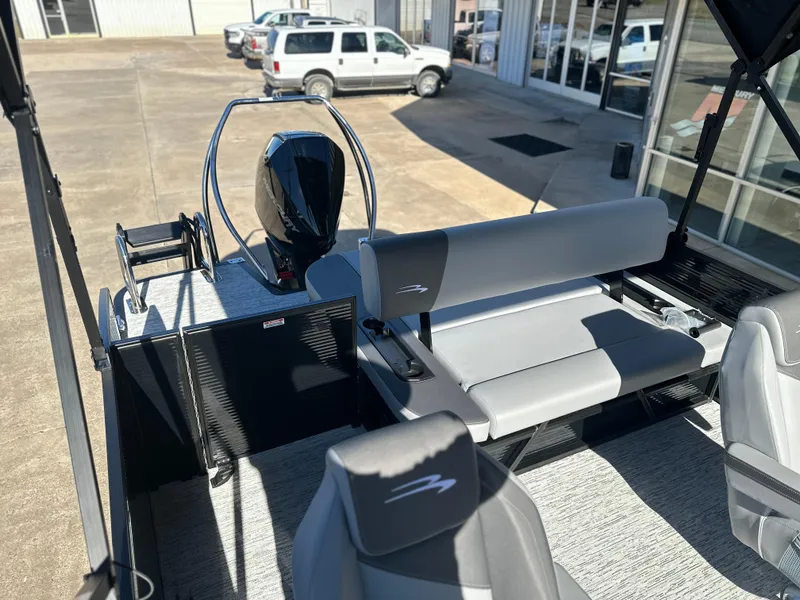 Slide: The Image of 2025 Bennington 23 SSB pontoon boat interior with seating and motor. - 8
