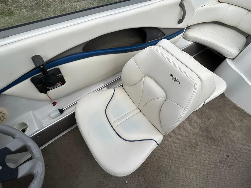 Slide: The Image of 2001 Four Winns 180 Horizon boat interior with white seating and steering wheel. - 10