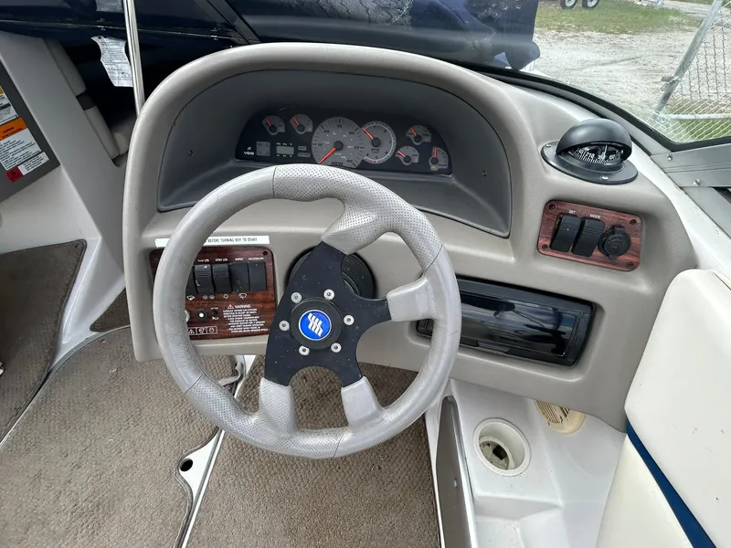 Slide: The Image of 2001 Four Winns 180 Horizon boat dashboard with steering wheel and instrument panel. - 11