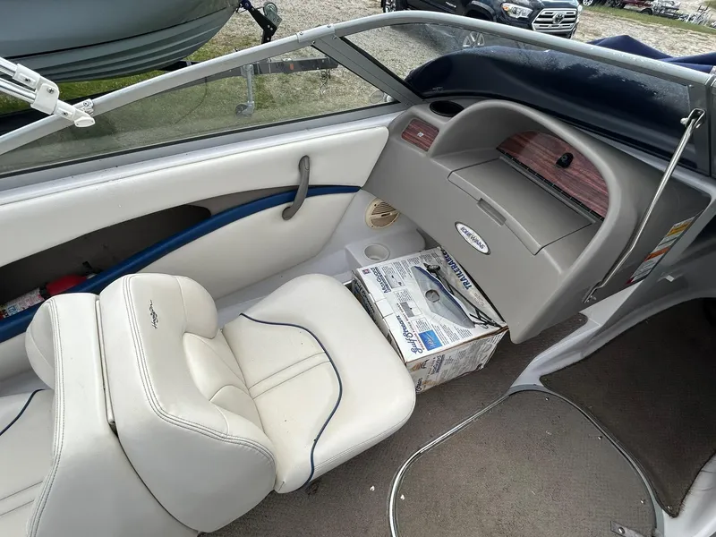 Slide: The Image of 2001 Four Winns 180 Horizon boat interior with white seating and dashboard. - 12