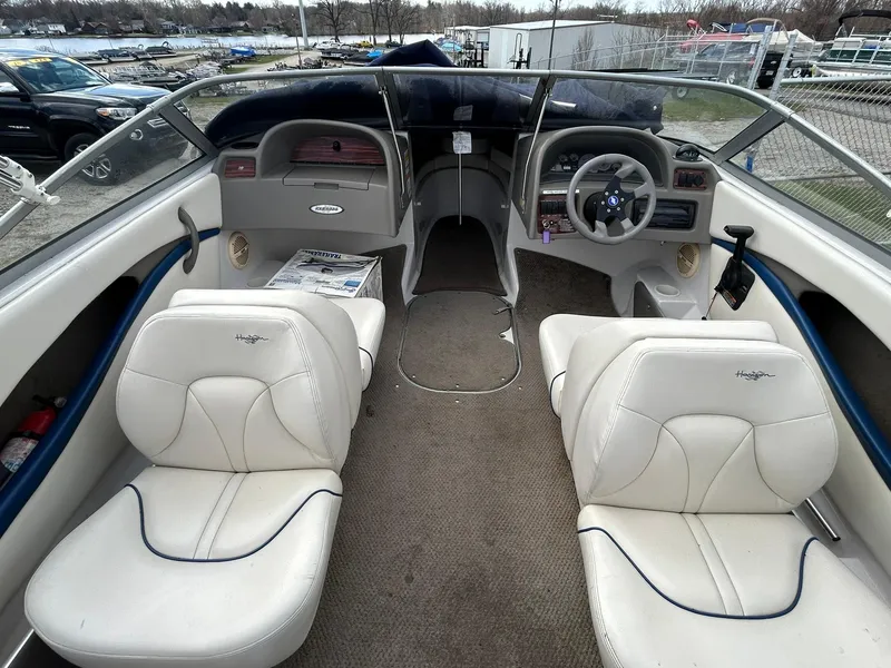Slide: The Image of 2001 Four Winns 180 Horizon boat interior with white seating and steering console. - 14