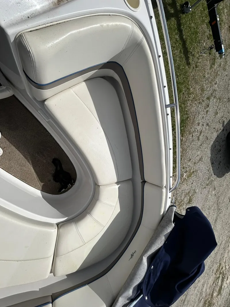 Slide: The Image of 2001 Four Winns 180 Horizon boat interior with white cushioned seating. - 15