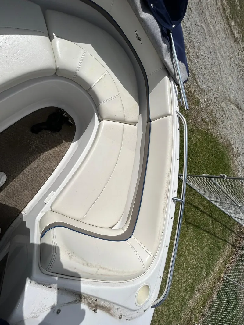 Slide: The Image of 2001 Four Winns 180 Horizon boat interior with white seating and metal railing. - 16