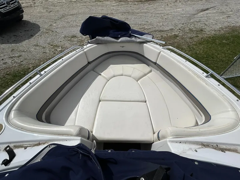 Slide: The Image of 2001 Four Winns 180 Horizon boat interior with white cushioned seating. - 18