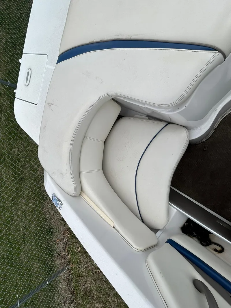Slide: The Image of 2001 Four Winns 180 Horizon boat interior seating with white and blue upholstery. - 2