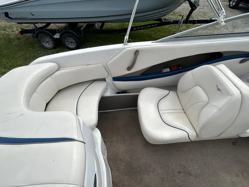 Slide: The Image of 2001 Four Winns 180 Horizon boat interior with white seating and blue accents. - 6