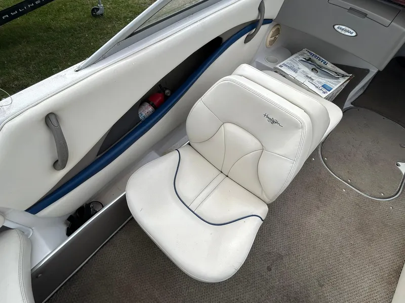 Slide: The Image of 2001 Four Winns 180 Horizon boat interior with white seating and carpeted floor. - 7
