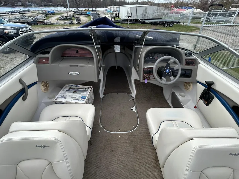 Slide: The Image of 2001 Four Winns 180 Horizon boat interior with white seating and dashboard view. - 8