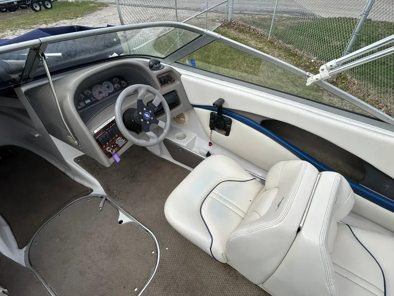 Slide: The Image of 2001 Four Winns 180 Horizon boat interior with steering wheel and seating. - 9