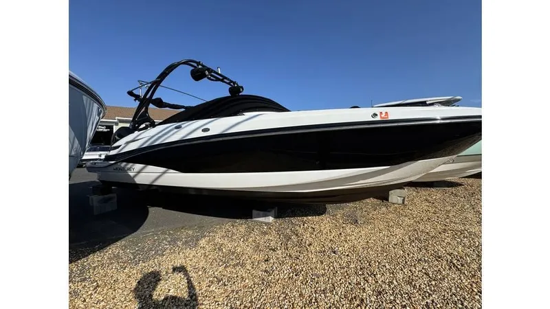 The Image of 2020 Monterey M65 boat on display, black and white design, parked on gravel. - 0