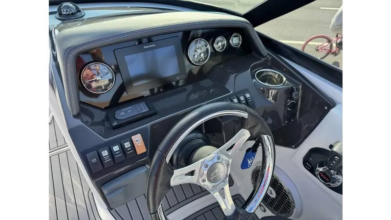 Slide: The Image of 2020 Monterey M65 boat dashboard with steering wheel and control panel. - 5