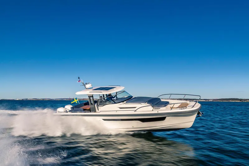 Slide: The Image of Nimbus Tender 11, 2025 model, cruising swiftly on open water under clear blue skies. - 15