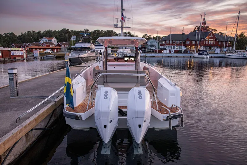 Slide: The Image of Nimbus Tender 11, 2025 model, docked at scenic marina during sunset. - 17
