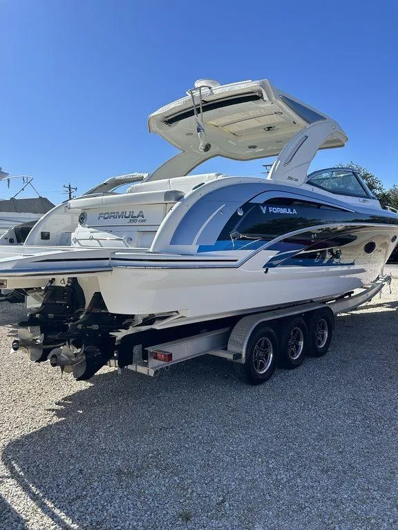 Slide: The Image of 2023 Formula 350 Crossover Bowrider on trailer, sleek design, sunny day. - 11