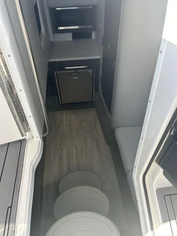 Slide: The Image of 2023 Formula 350 Crossover Bowrider interior with modern kitchenette and seating area. - 12