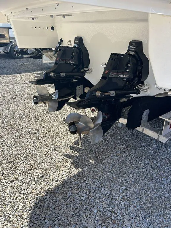 Slide: The Image of 2023 Formula 350 Crossover Bowrider boat propellers on gravel surface. - 13