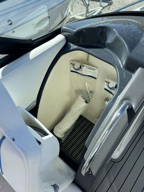 Slide: The Image of 2023 Formula 350 Crossover Bowrider interior storage compartment with cup holders. - 22