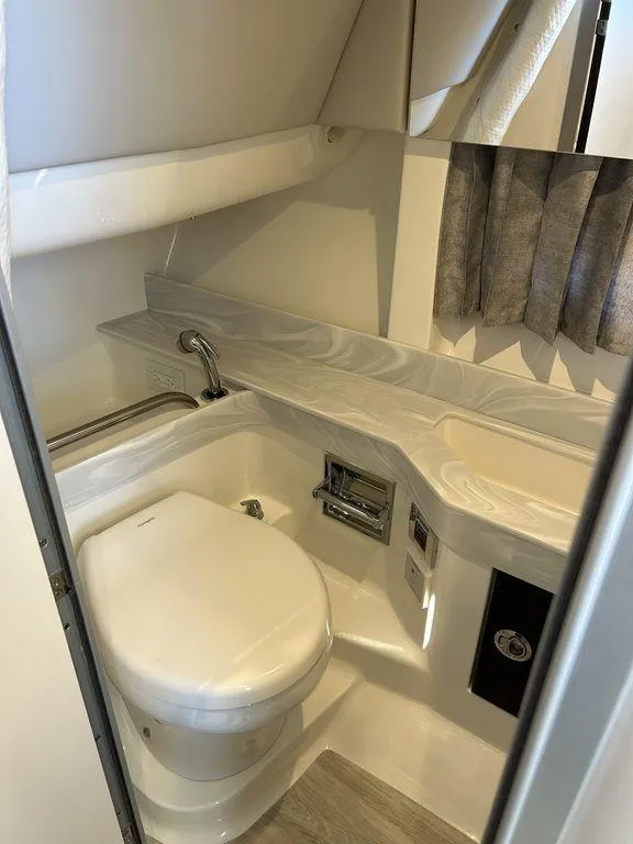 Slide: The Image of 2023 Formula 350 Crossover Bowrider bathroom with modern fixtures and sleek design. - 23