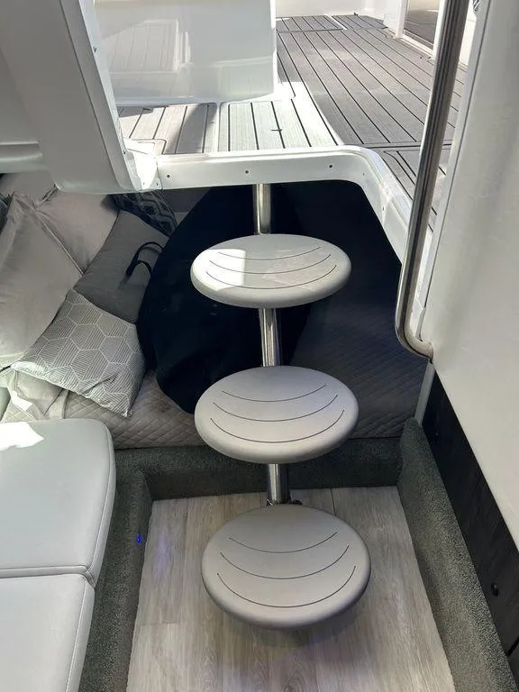 Slide: The Image of Interior of 2023 Formula 350 Crossover Bowrider with modern circular steps and cozy seating area. - 25
