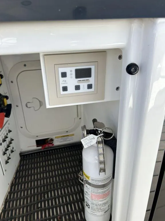 Slide: The Image of 2023 Formula 350 Crossover Bowrider interior with control panel and fire extinguisher. - 26