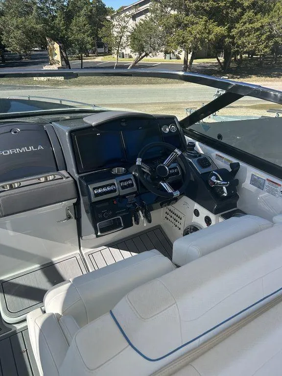 Slide: The Image of 2023 Formula 350 Crossover Bowrider cockpit with modern controls and white seating. - 9