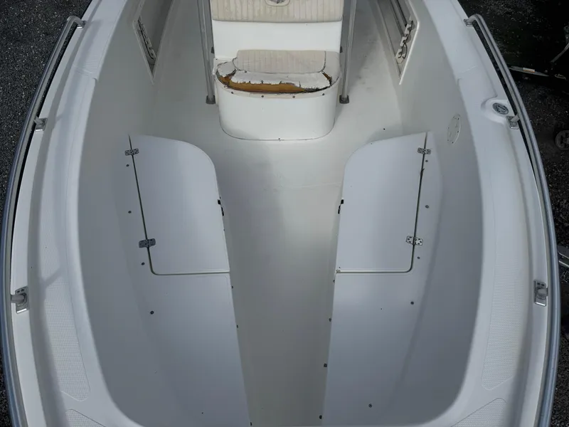Slide: The Image of 2008 Mako 212 Center Console boat interior, featuring spacious seating and storage compartments. - 11