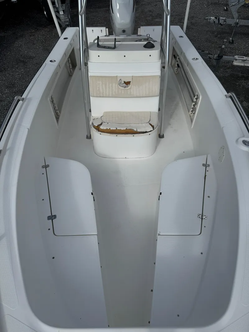 Slide: The Image of 2008 Mako 212 Center Console boat interior with storage compartments and seating. - 12