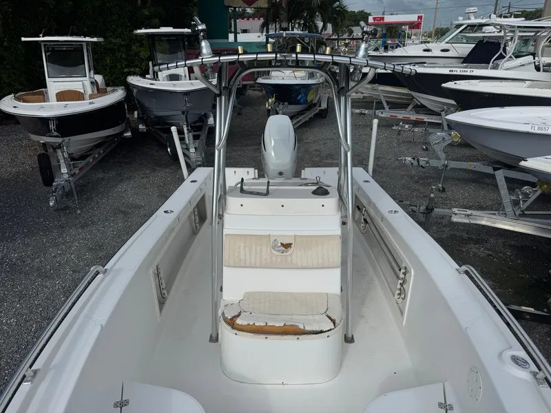 Slide: The Image of 2008 Mako 212 Center Console boat in a marina with other vessels. - 13