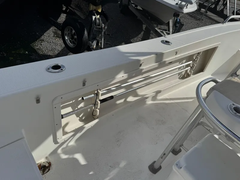 Slide: The Image of 2008 Mako 212 Center Console boat interior with rod holders and seating. - 6