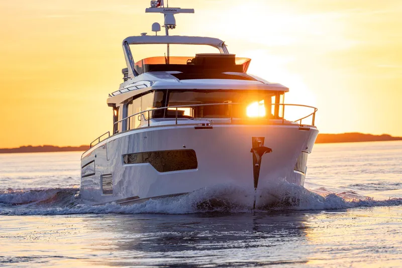 The Image of Nimbus 495 Flybridge 2025 yacht cruising at sunset on open water. - 0
