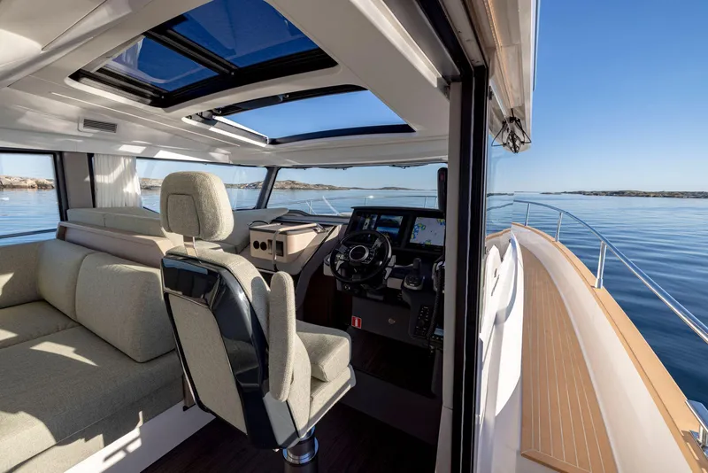 Slide: The Image of Interior view of 2025 Nimbus 495 Flybridge yacht with modern helm and seating. - 28