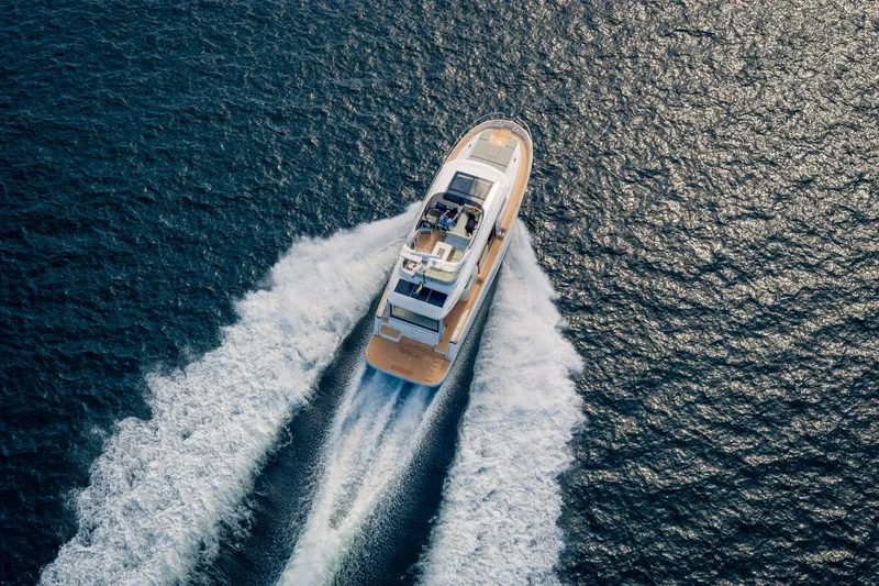 Slide: The Image of Nimbus 495 Flybridge 2025 cruising on open water, aerial view. - 29
