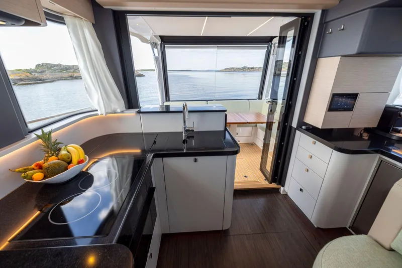 Slide: The Image of Luxurious 2025 Nimbus 495 Flybridge yacht interior with modern kitchen and ocean view. - 33