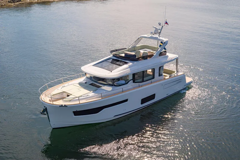 Slide: The Image of 2025 Nimbus 495 Flybridge yacht cruising on calm waters. - 37