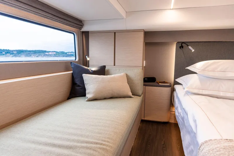 Slide: The Image of Luxurious 2025 Nimbus 495 Flybridge cabin with cozy bed and scenic window view. - 42