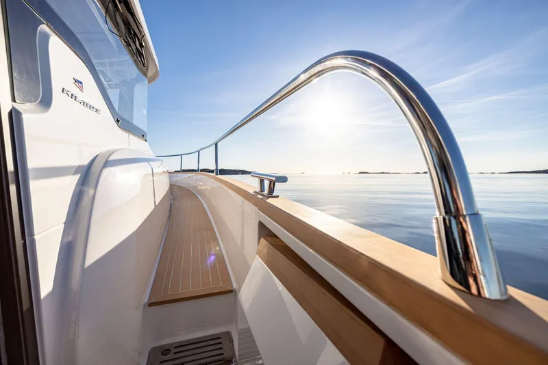 Slide: The Image of Nimbus 495 Flybridge 2025 yacht, sleek design, sunlit deck, calm waters. - 5