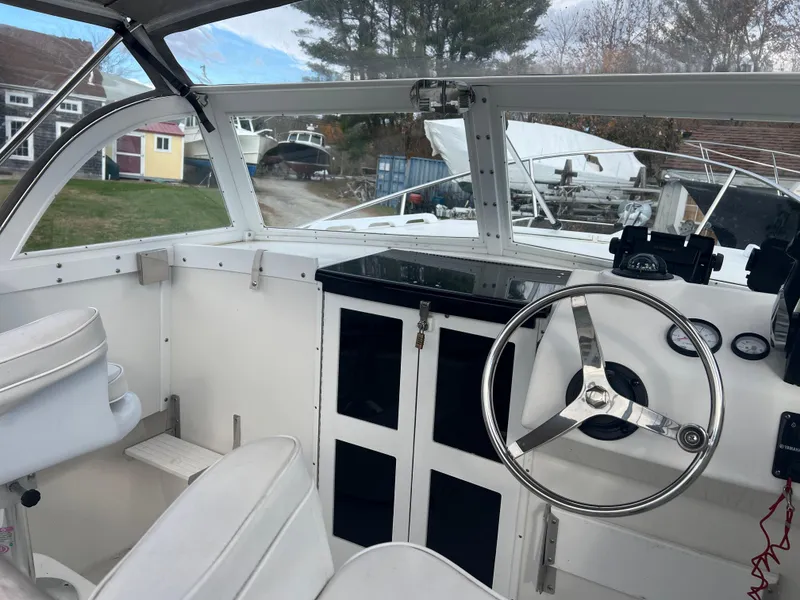 Slide: The Image of 2020 Seaway 21 Seafarer Cuddy boat interior with steering wheel and seating. - 3