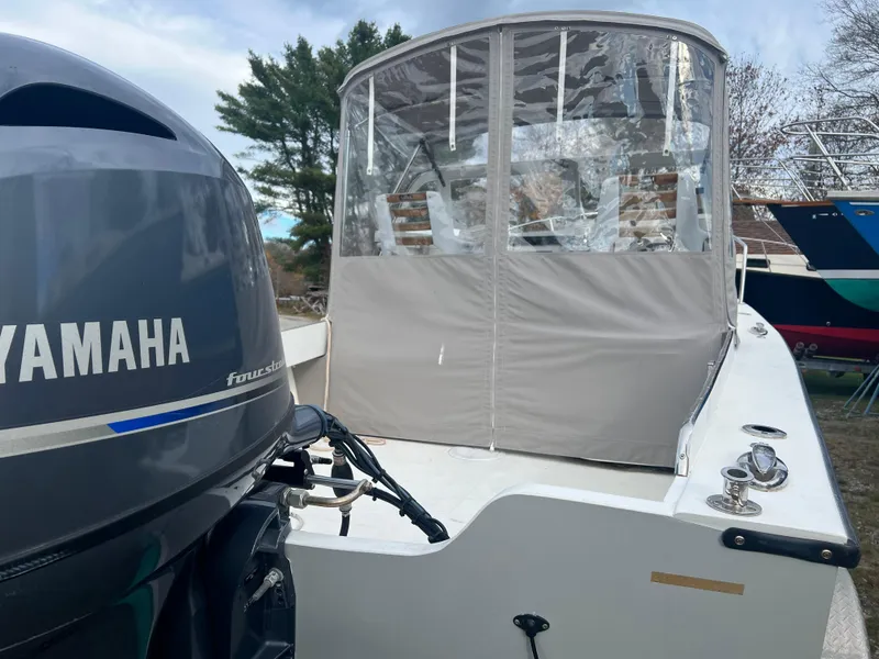 Slide: The Image of 2020 Seaway 21 Seafarer Cuddy with Yamaha outboard motor, docked outdoors. - 4