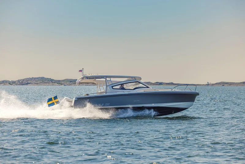 Slide: The Image of Nimbus Weekender 9 boat cruising on open water, 2025 model. - 12