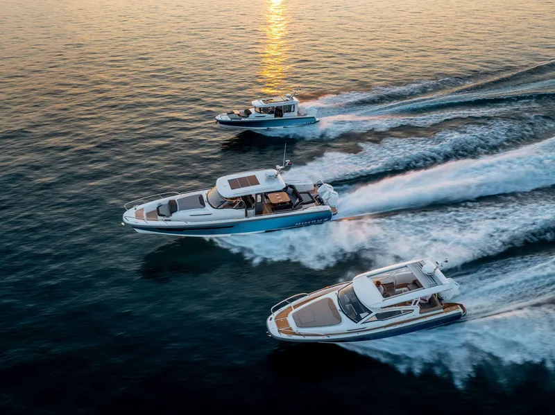 Slide: The Image of Three Nimbus Weekender 9 boats cruising on the water at sunset, 2025 model. - 21