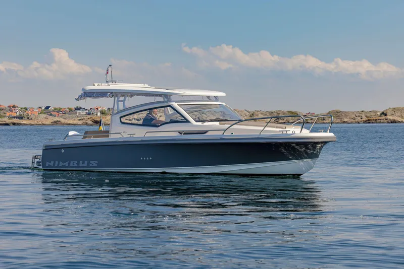 Slide: The Image of 2025 Nimbus Weekender 9 boat cruising on calm waters under a clear sky. - 22