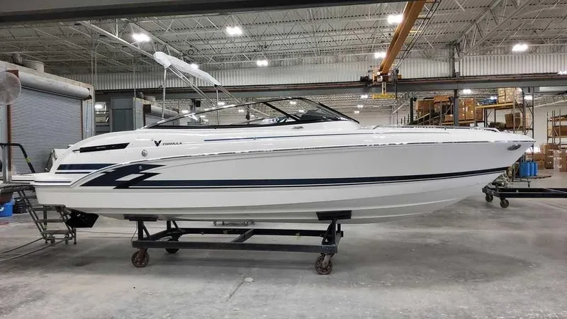 The Image of 2025 Formula 240 Bowrider boat in a warehouse setting. - 1