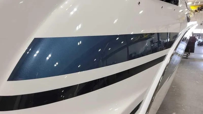 Slide: The Image of Close-up of 2025 Formula 240 Bowrider boat with sleek blue and white design. - 6