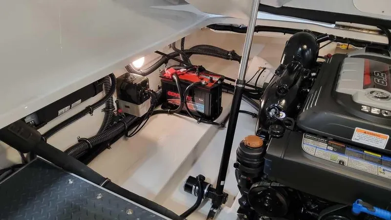 Slide: The Image of 2025 Formula 240 Bowrider engine compartment with battery and wiring. - 9