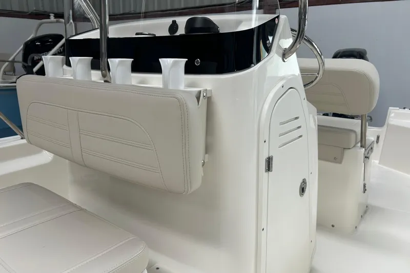 Slide: The Image of 2025 Boston Whaler 150 Montauk boat interior with white seating and storage compartment. - 13