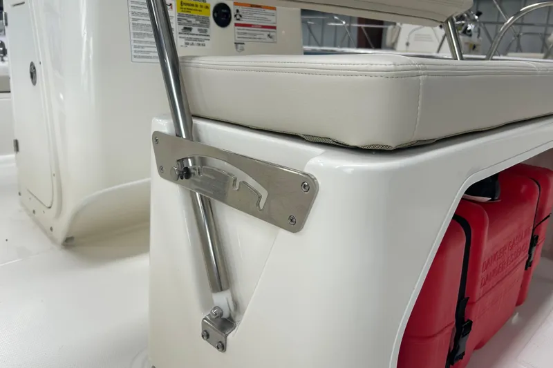 Slide: The Image of 2025 Boston Whaler 150 Montauk boat seat detail with red storage container. - 21