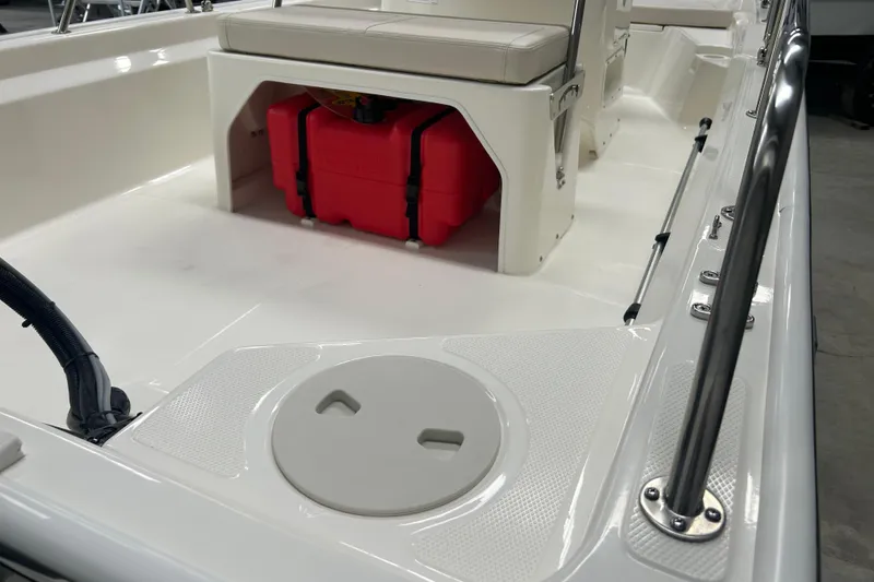 Slide: The Image of 2025 Boston Whaler 150 Montauk interior with red storage container and seating. - 22